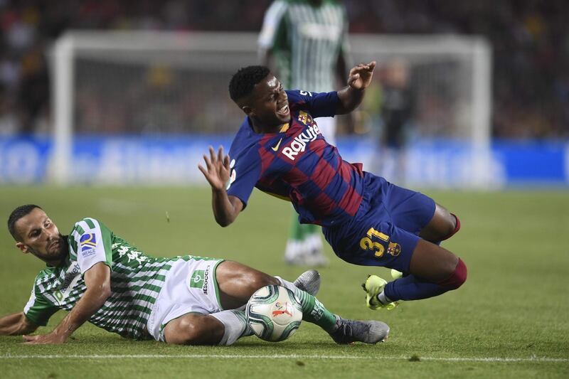 Betis midfielder Alfonso Pedraza challenges Barcelona´s Guinea-Bissau forward Ansu Fati. AFP