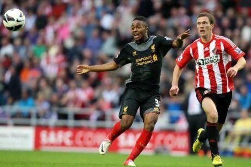 Liverpool's Raheem Sterling, left, vies for the ball with Sunderland's Craig Gardner during their English Premier League match at the Stadium of Light, Sunderland. Scott Heppell / AP Photo