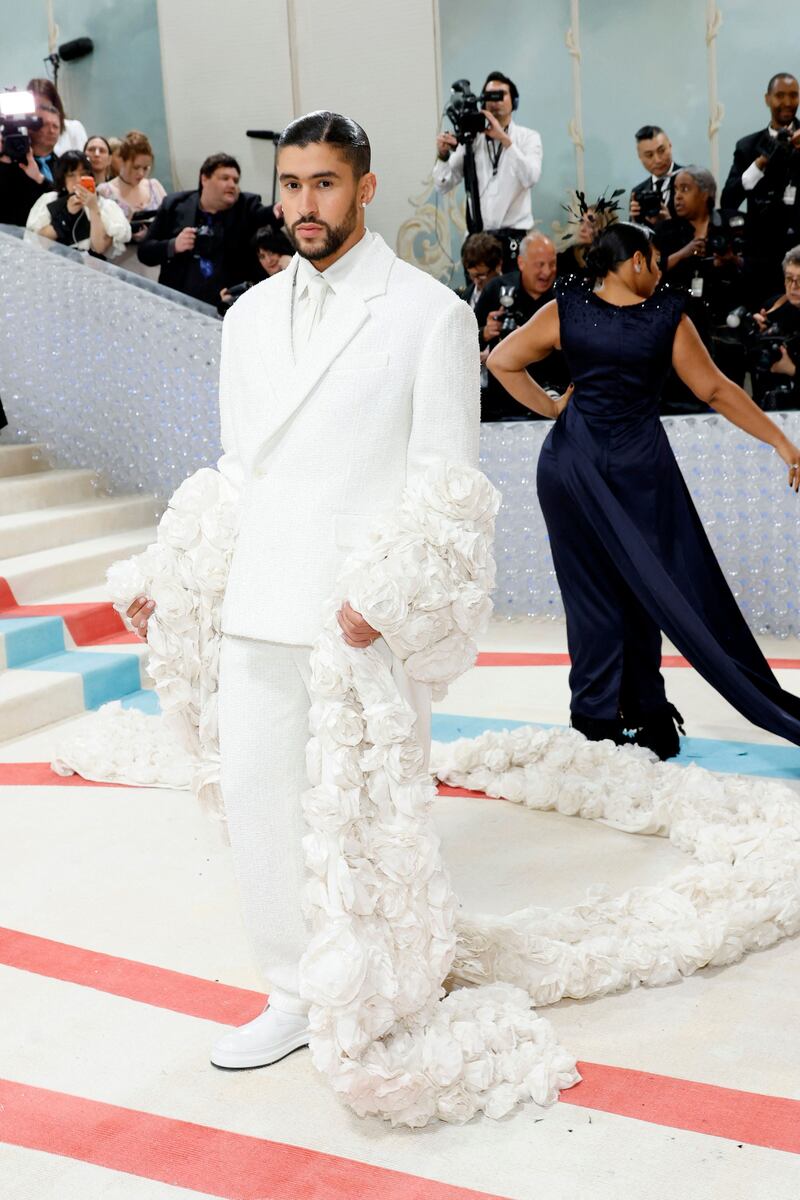 Bad Bunny in a white suit and floral cape by Jacquemus. Getty Images