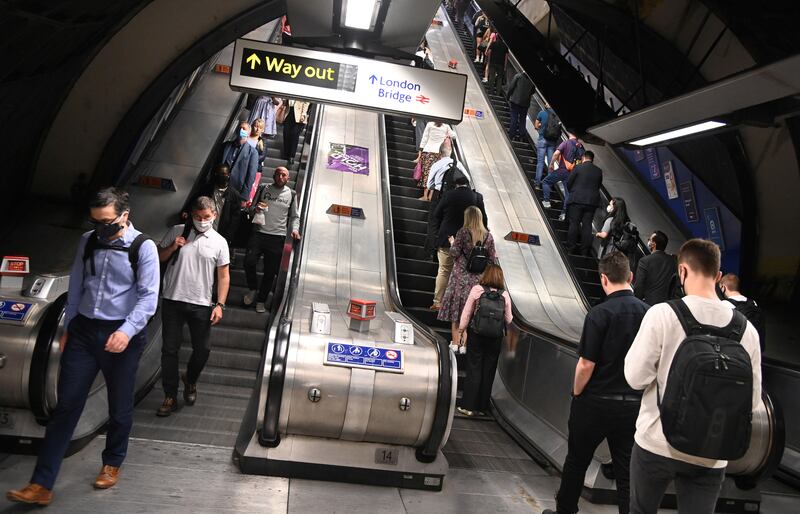 Passengers travel through London Bridge rail and underground station during the morning rush hour in London. TfL bosses say escalator falls are on the rise amid fears the handrails could contain traces of Covid. Reuters