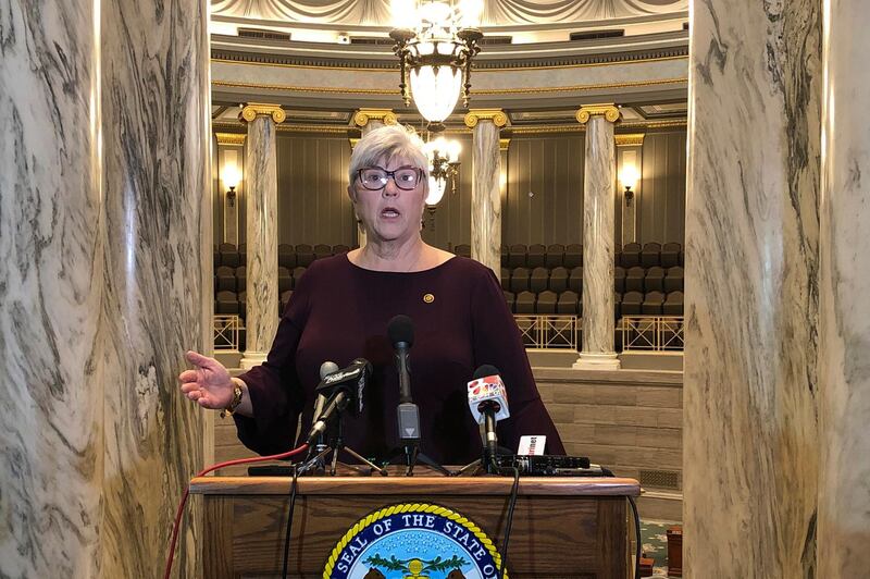 In this Jan. 9, 2019, photo, Missouri state Sen. Gina Walsh speaks to reporters from the gallery of the state Senate in Jefferson City, Mo., on the opening day of the 2019 legislative session. Walsh is among numerous lawmakers nationwide who decided to stay at home instead of attend in-person legislative sessions in April 2020 because of concerns about the coronavirus. (AP Photo/David A. Lieb)