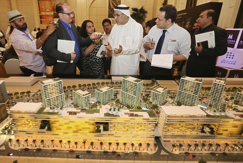 Saeed Al Qatami, CEO of Deyaar Development, next to a scale model of the Midtown development at International Media Production Zone, on display at Shangri-La Hotel in Dubai. Sarah Dea / The National