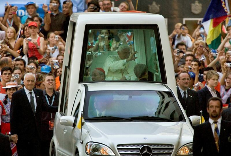 COLOGNE, GERMANY - AUGUST 18: Pope Benedict XVI  waves from his popemobile to the pilgrims in front of  the Cologne Cathedral on August 18, 2005 in Cologne, Germany. Thousands of young Catholics are arriving in Germany for the World Youth Day with Pope Benedict XVI, who will lead an open-air mass on August 21 which is expected to attract 800,000 worshippers from 193 countries. (Photo by Carsten Koall/Getty Images) 