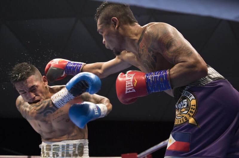 Dubai, United Arab Emirates - Donnie Nietes of the Philippines (right) hitting Pablo Carillo of Colombia at the Rotunda, Ceasar's Palace, Bluewaters Island, Dubai.  Leslie Pable for The National