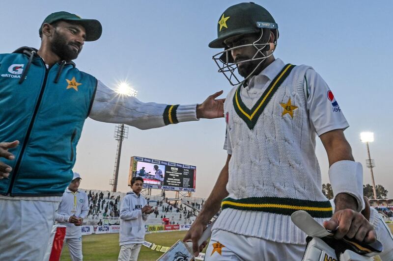 Pakistan's Babar Azam (R) walks back to the pavilion after unbeaten 143 runs at the end of the second day of the first cricket Test match between Pakistan and Bangladesh at the Rawalpindi Cricket Stadium in Rawalpindi on February 8, 2020. / AFP / AAMIR QURESHI

