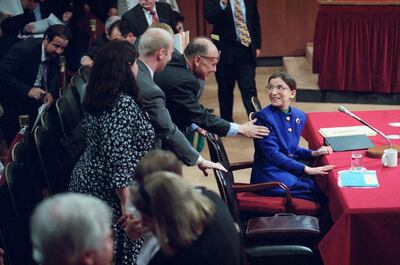 Supreme Court nominee Judge Ruth Bader Ginsburg is greeted by her husband Martin as she introduced her family during her confirmation hearing before the Senate Judiciary Committee on Capitol Hill on Tuesday, July 20, 1993 in Washington. Ginsburg's son James and wife Lisa Brauston are at left. (AP Photo/John Duricka)