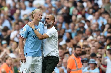 Manchester City manager Pep Guardiola (R) hugs his player Erling Haaland (L) after substitution during the English Premier League soccer match between Manchester City and AFC Bournemouth in Manchester, Britain, 13 August 2022.   EPA/PETER POWELL EDITORIAL USE ONLY.  No use with unauthorized audio, video, data, fixture lists, club/league logos or 'live' services.  Online in-match use limited to 120 images, no video emulation.  No use in betting, games or single club / league / player publications