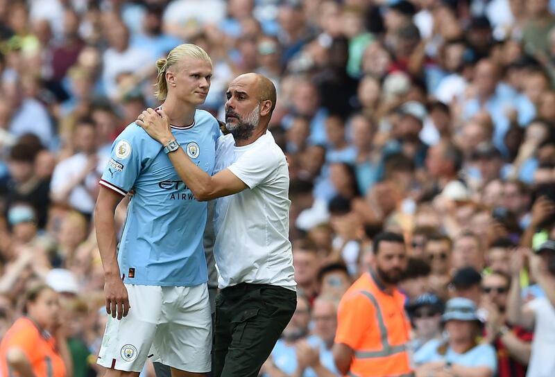 Manchester City manager Pep Guardiola hugs Erling Haaland after substituting the striker. EPA