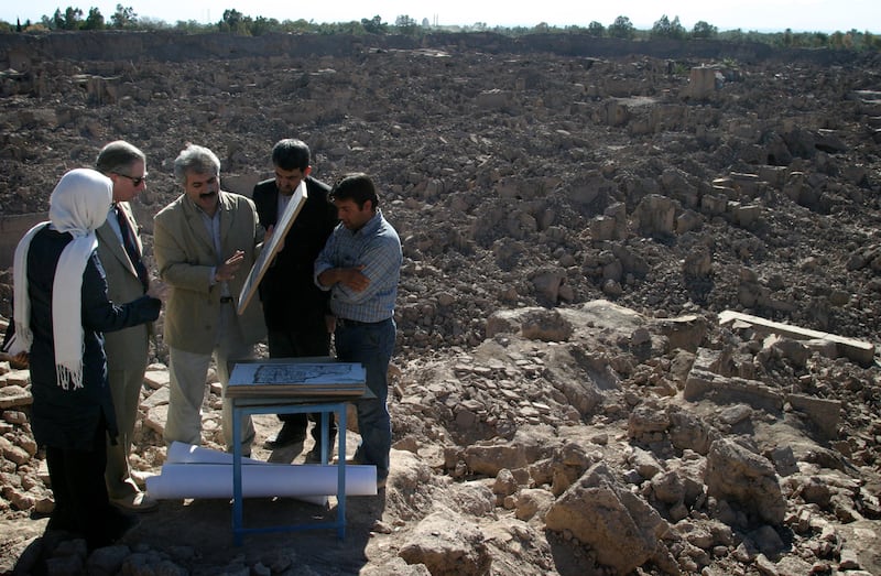 The UK royal is shown a map of Arg-e-Bam during a 2004 visit to the ruins in Bam, southern Iran. Reuters