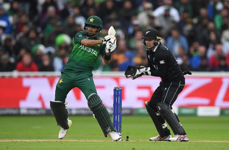BIRMINGHAM, ENGLAND - JUNE 26: Babar Azam of Pakistan plays a shot as Tom latham of New Zealand looks on during the Group Stage match of the ICC Cricket World Cup 2019 between New Zealand and Pakistan at Edgbaston on June 26, 2019 in Birmingham, England. (Photo by Alex Davidson/Getty Images)