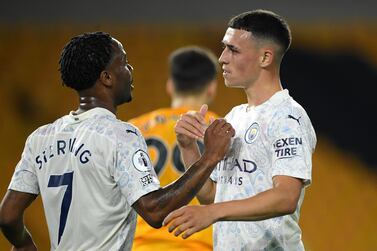 Phil Foden, right, is congratulated by Raheem Sterling after scoring Manchester City's second goal against Wolves. AP Photo