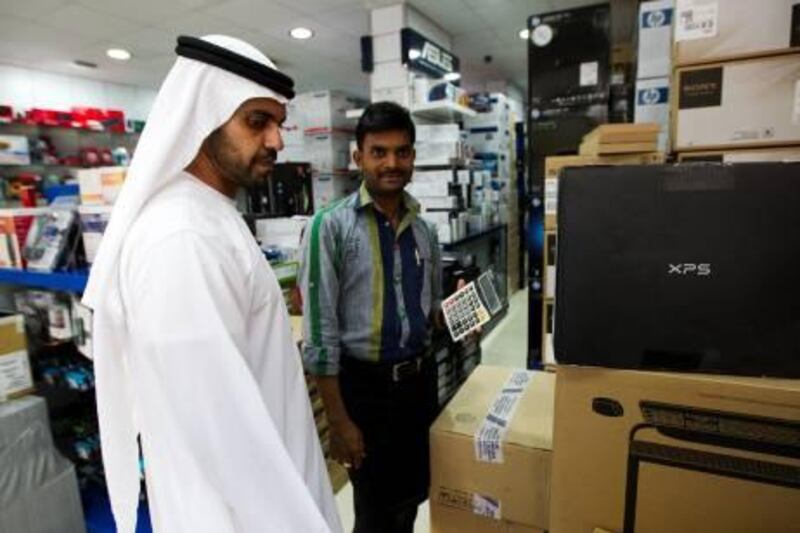 Dubai, Feb 22th, 2012 -- National reporter Thamer Subaihi goes shopping in the elctronics district in Bur Dubai dressed as an Emirati, February 21, 2012. (Sarah Dea/ The National)