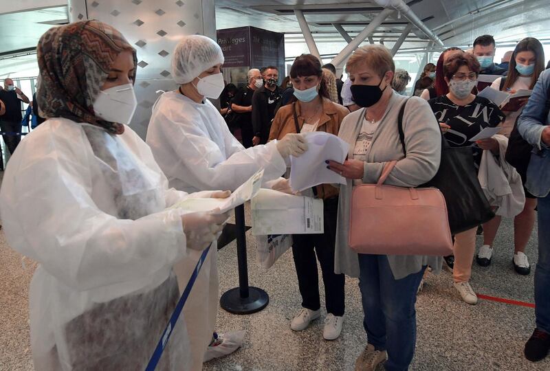 Tunisian health workers check European tourists upon arrival at Enfidha-Hammamet International Airport near the town of Sousse. AFP