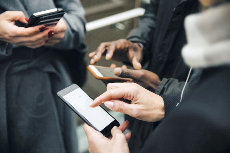 A common sight: browsing social media on phones at the cost of real human interactions. Getty