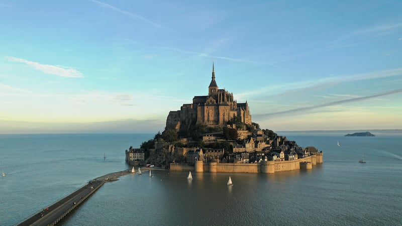 An aerial view shows Mont-Saint-Michel surrounded by sea at sunrise, during the highest tide of the year, on France's Normandy coast. Reuters