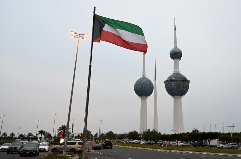 The Kuwaiti flag flying in Kuwait City. The government has cancelled events to mark National Day and Liberation Day, on February 25 and 26, to curb the spread of Covid-19. EPA
