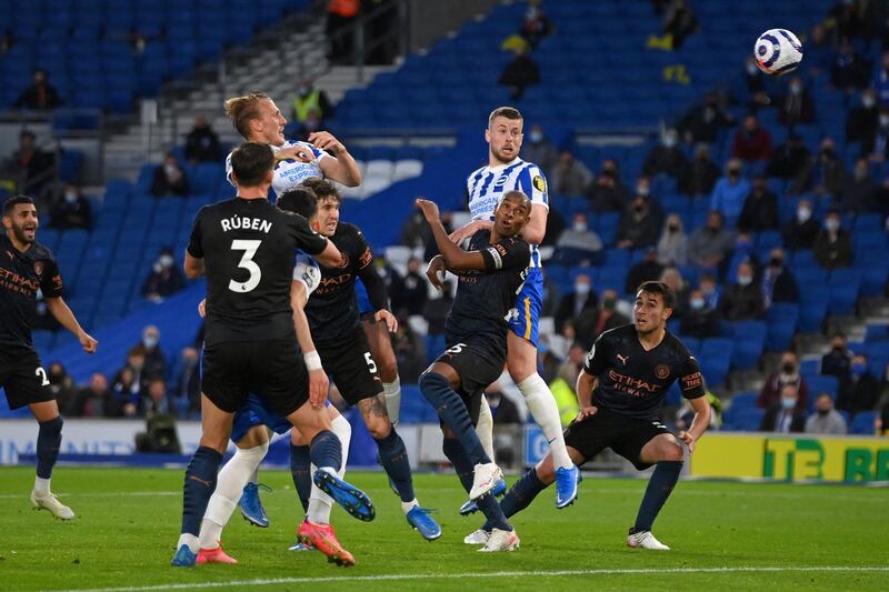 Brighton's English defender Adam Webster (C) scores his team's second goal during the English Premier League football match between Brighton and Hove Albion and Manchester City at the American Express Community Stadium in Brighton, southern England on May 18, 2021. RESTRICTED TO EDITORIAL USE. No use with unauthorized audio, video, data, fixture lists, club/league logos or 'live' services. Online in-match use limited to 120 images. An additional 40 images may be used in extra time. No video emulation. Social media in-match use limited to 120 images. An additional 40 images may be used in extra time. No use in betting publications, games or single club/league/player publications.
 / AFP / POOL / Mike Hewitt / RESTRICTED TO EDITORIAL USE. No use with unauthorized audio, video, data, fixture lists, club/league logos or 'live' services. Online in-match use limited to 120 images. An additional 40 images may be used in extra time. No video emulation. Social media in-match use limited to 120 images. An additional 40 images may be used in extra time. No use in betting publications, games or single club/league/player publications.
