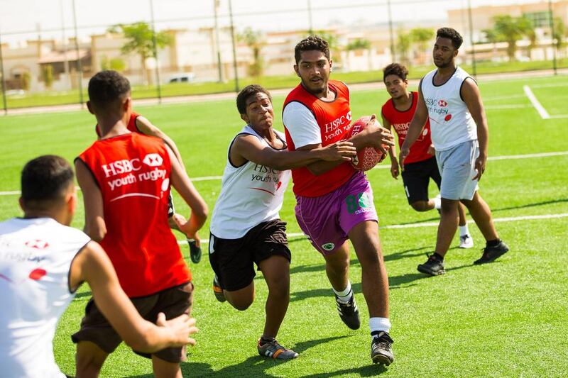 Young payers from Hamden bin Rashed High School in a training session with Ben Ryan and Chris Cracknell. Courtesy HSBC Youth Rugby