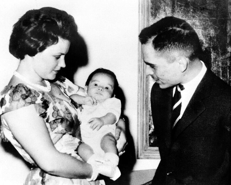 Picture dated 1963 shows Jordan King Hussein and his first wife Queen Mona looking at their eldest son Abdallah in Amman. The King has named Abdallah, 36, crown prince 25 January after sacking his brother from the position in a harshly critical letter. (Photo by ROYAL FAMILY ALBUM / AFP)