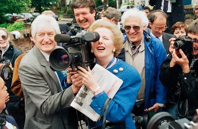 British Prime Minister Margaret Thatcher tries her hand with a television camera in London in 1987. AP Photo