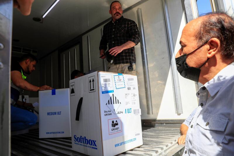 Personnel check the first shipment of the Pfizer's vaccine against the coronavirus disease (COVID-19) at Baghdad International Airport, in Baghdad, Iraq April 11, 2021. REUTERS/Thaier Al-Sudani