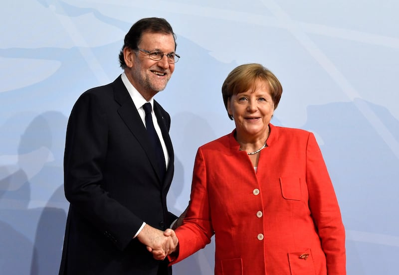 German chancellor  greets Spain's Prime Minister Mariano Rajoy. John MacDougall / AFP Photo