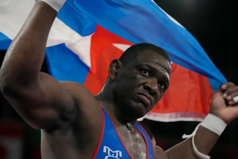 Cuba's Mijain Lopez Nunez celebrates defeating Georgia's Lakobi Kajaia during the men's 130kg Greco-Roman wrestling final.