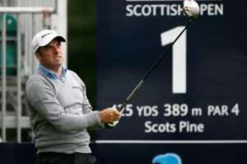 Paul McGinley from Ireland tees off on the first hole at the start of his first round of the Scottish Open golf tournament at Loch lommond near Glasgow, Scotland July 10, 2008. REUTERS/David Moir (BRITAIN) *** Local Caption ***  LOM15_GOLF-EUROPEAN_0710_11.JPG