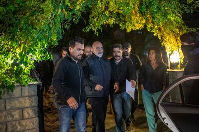 Journalist and writer Ahmet Altan (C) walks with Turkish police as his daughter Senem Altan (R) tries to say him goodbye as he is detained on November 12, 2019, at Kadikoy neighbourhood in Istanbul. A Turkish court on November 12 ordered the arrest of prominent journalist Ahmet Altan just a week after his release from prison over alleged links to the failed 2016 coup, state media reported. / AFP / BULENT KILIC
