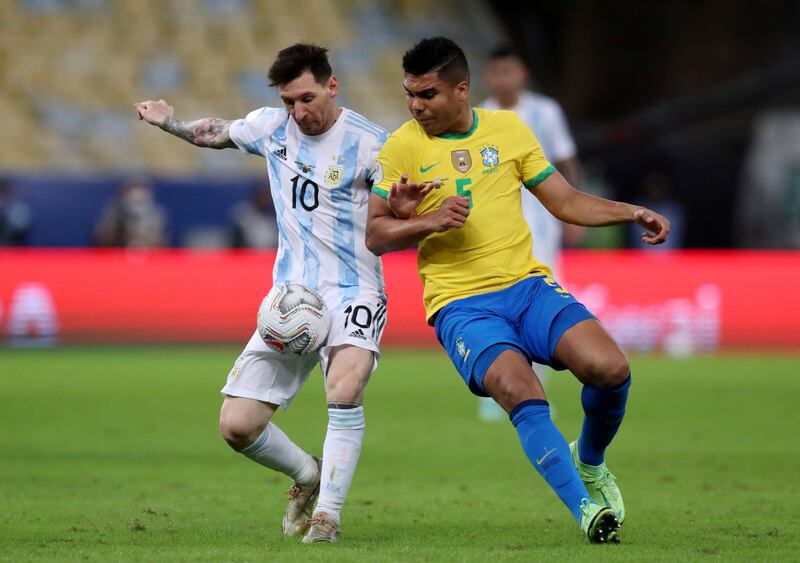 Brazil midfielder Casemiro in action with Argentina's Lionel Messi in the 2021 Copa America final. Reuters