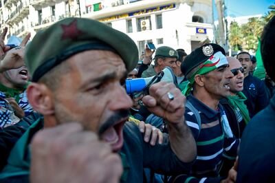 Veteran soldiers from Algeria's civil war shout slogans during a demonstration against ailing President Abdelaziz Bouteflika in the capital Algiers on March 29, 2019. Hundreds of Algerians gathered in the capital at the start of new protests to pressure ailing President Abdelaziz Bouteflika to step down or be removed, as many of his loyalists quit his side. / AFP / RYAD KRAMDI                        
