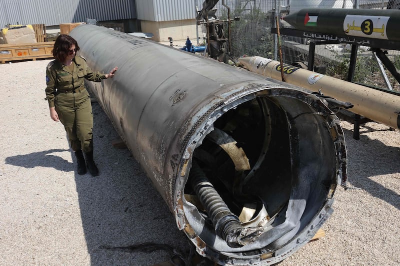 An Israeli soldier stands next to an Iranian ballistic missile that purportedly fell on Israel at the weekend. AFP