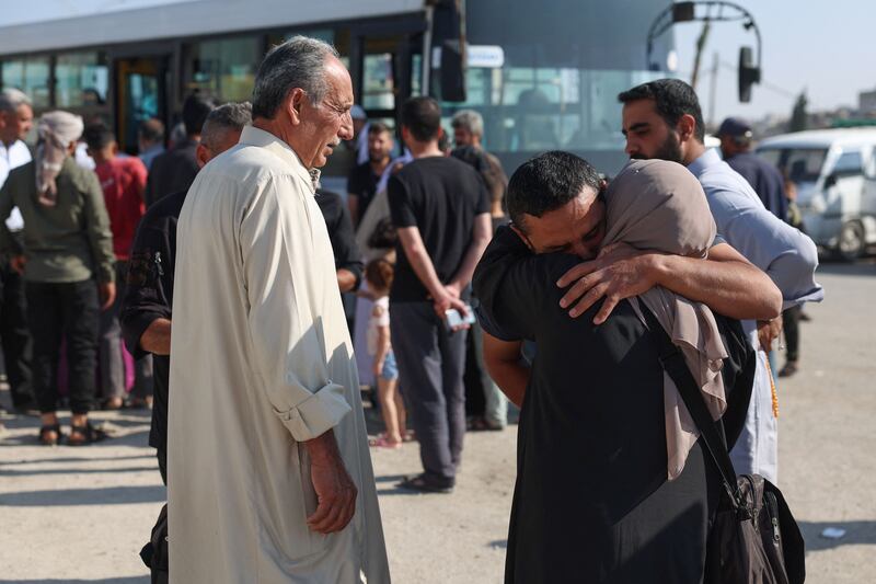 People bid relatives farewell as pilgrims board a bus in Sarmada town in Syria's north-western Idlib province. AFP