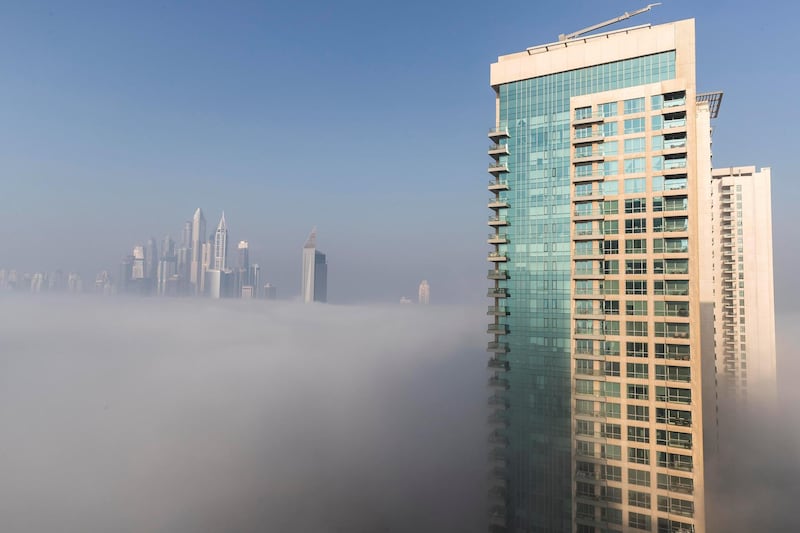 DUBAI, UNITED ARAB EMIRATES. 28 DECEMBER 2017. High rise buildings tower above the low lying fog in Dubai. (Photo: Antonie Robertson/The National) Journalist: None. Section: National.