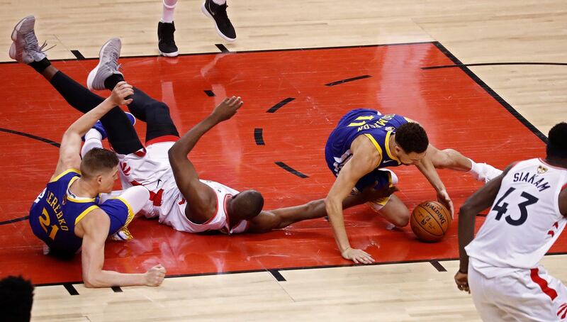 Toronto Raptors player Serge Ibaka goes for a loose ball against Golden State Warriors players Jonas Jerebko. EPA