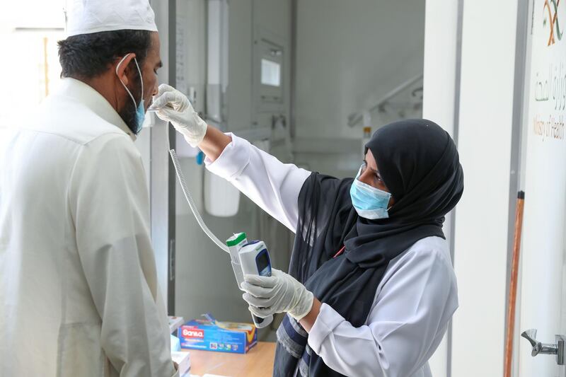 A Saudi nurse checks a patient's temperature at a mobile clinic in the Ajyad Almasafi district in the holy city of Makkah. AFP