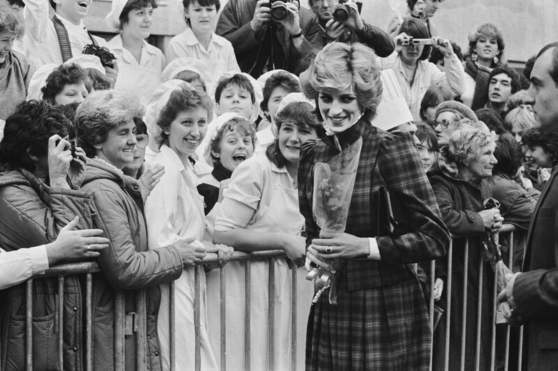 Diana, Princess of Wales (1961-1997) wearing a tartan dress by Caroline Charles as she meets well wishers during a visit to Bridgend, Wales, 29th January 1985. (Photo by Stroud/Daily Express/Hulton Archive/Getty Images)