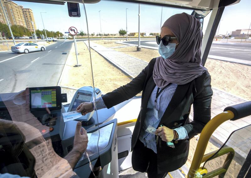 Abu Dhabi, United Arab Emirates, January 20, 2021.  One must collect a "Park and Ride Ticket" from a security guard before entering the bus.
Victor Besa/The National 
Section:  NA
Reporter:  Nilanjana Gupta