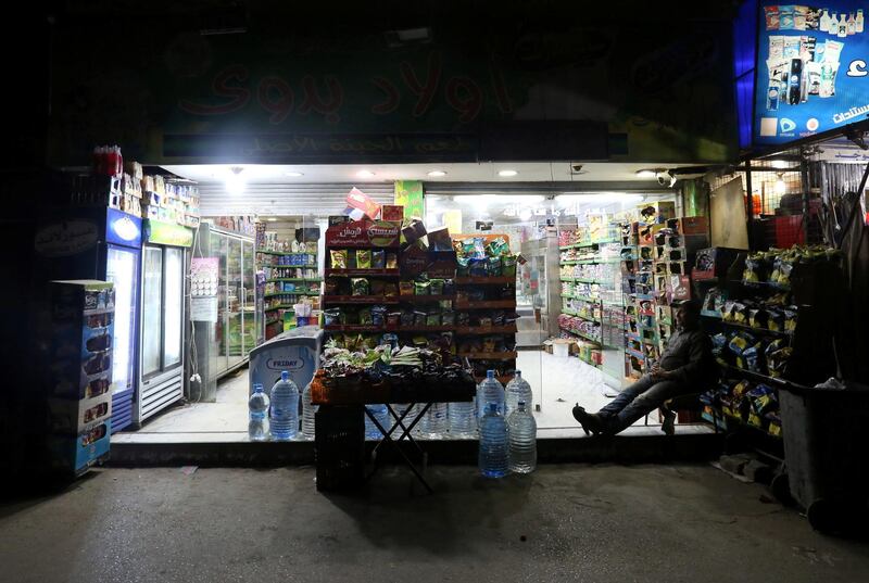 A vendor sits at his shop during a curfew in Cairo, Egypt. Reuters