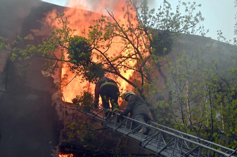 Firefighters tackle a blaze in a residential building, after a bombardment in central Kharkiv. AFP