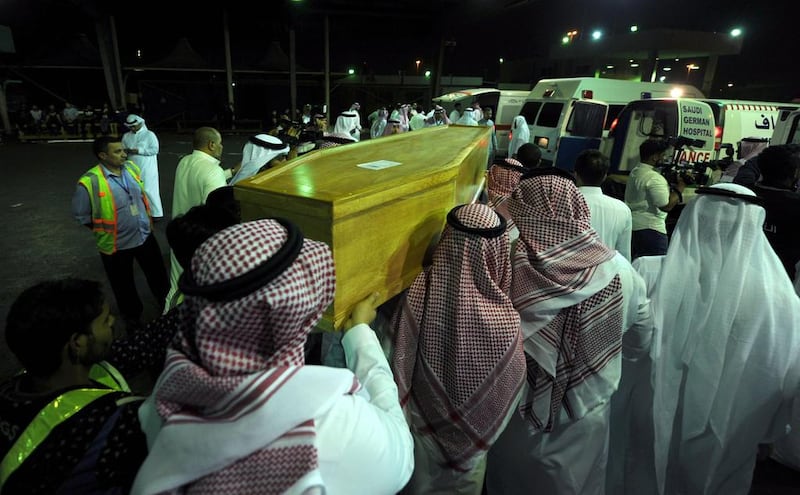 Men carry the coffins of Saudi victims who were killed in an attack on the Reina night club on New Year's eve in Istanbul, upon their arrival to the Jeddah international airport on late January 2, 2017.  / AFP / Amer Hilabi

