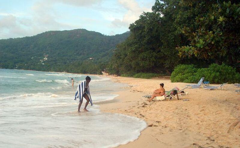Tourists relax on a beach in Beau Vallon, Seychelles. The rising sea level due to global warming is taking a bite out of the Indian Ocean nation´s beaches, the number one tourist attraction.