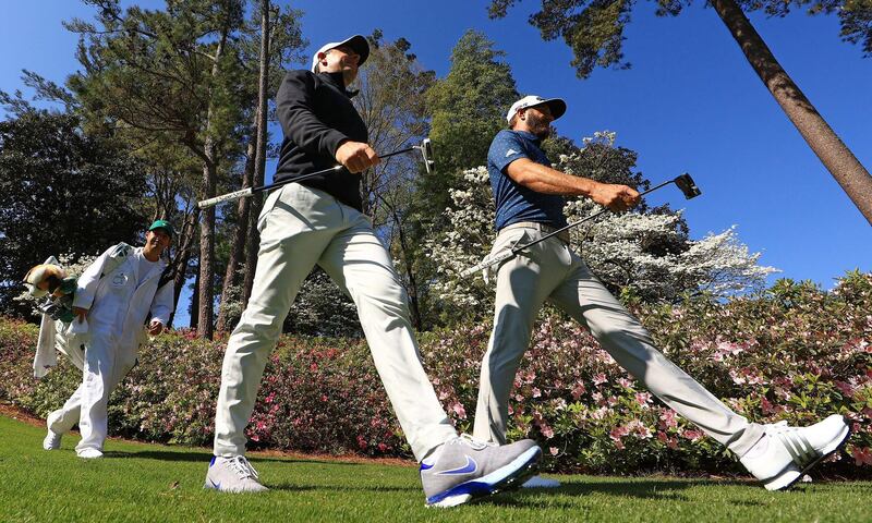 Dustin Johnson and Rory McIlroy walk on the sixth hole during a practice round prior to the Masters at Augusta National. AFP