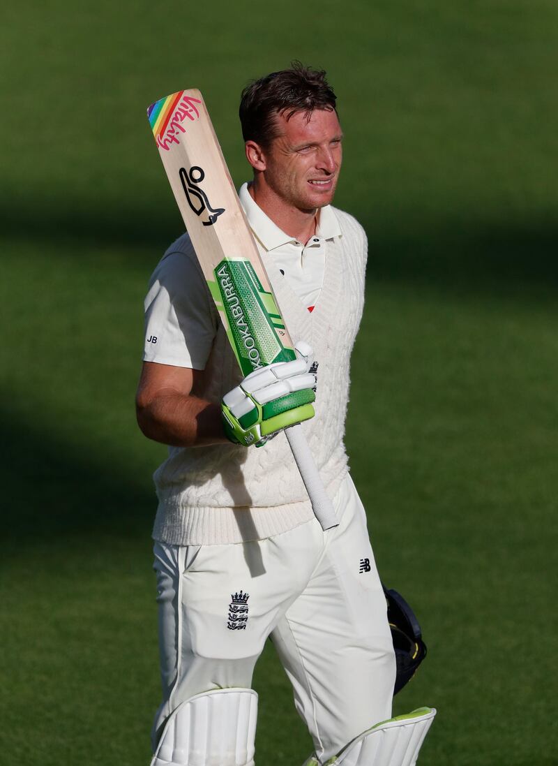 England's Jos Buttler acknowledges the applause from his teammates as he walks off the field after losing his wicket. AP