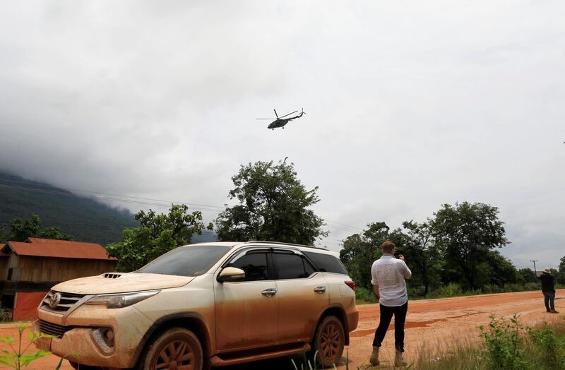 A military helicopter flies near flooded areas in Attapeu province, Laos. Reuters