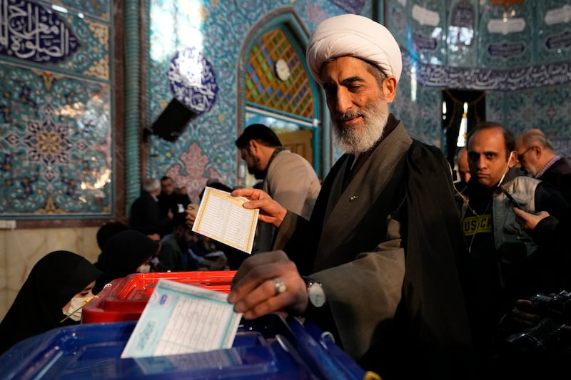 A cleric casts his ballot at a polling station in Tehran. AP