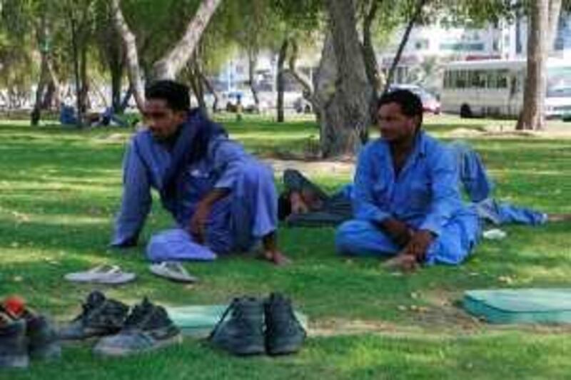 Abu Dhabi - May 27, 2009: Workers take a break near the Al Mamoura building. ( Philip Cheung / The National ) *** Local Caption ***  PC0021-workers.jpg