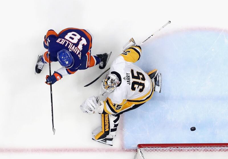 New York Islanders' Anthony Beauvillierf finishes past Tristan Jarry of the Pittsburgh Penguins in the Stanley Cup playoffs at the Nassau Coliseum on May 26. The Islanders won 5-3 to seal the series 4-2 and move on to face Boston. AFP