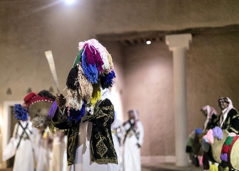 RIYADH, KINGDOM OF SAUDI ARABIA. 26 SEPTEMBER 2019. 
Saudi traditional dance performance inside At-Turaif district in Ad-Dariya.

At-Turaif was founded in the 15th century, with much influence owed to the Najdi architectural style of Arabia. In the mid-18th century, the sprawling mud-brick city spawned the dynasty of Al Saud, who had lived in Ad Diriyah since the 15th century. 

The largest single structure in the city is Salwa Palace, which extends over approximately 10,000 square metres and consists of seven main units. The palace contains the Ad Diriyah museum, with more museums set to come.
Former villa residences that once housed families in 18th-and 19th-century At-Turaif have been converted into a souq, plus an array of cubby­hole areas where demonstrations of traditional crafts now take place – calligraphy, medicine, carpet weaving and the making of weapons are among the attractions. Again, all the staff are Saudis.

(Photo: Reem Mohammed/The National)

Reporter:
Section: