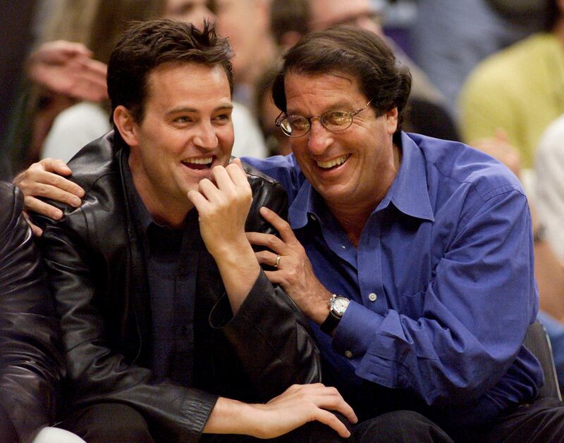 Perry and studio executive Peter Roth at an NBA game at the Staples Centre, Los Angeles, in 2000. Reuters